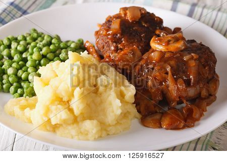 Salisbury Steak With Gravy, Mashed Potatoes And Green Peas. Horizontal