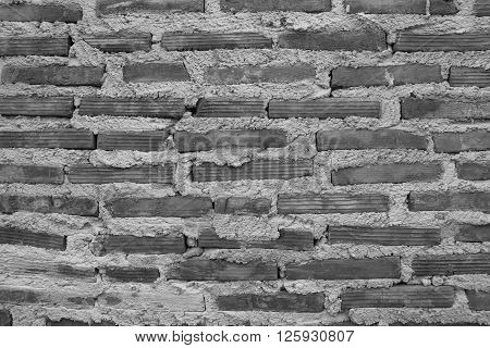 Brick wall placed on a vertical stick with a plaster waiting to shetland.