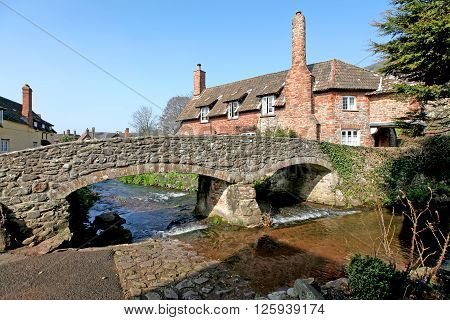 A picture-postcard English Village in northern Somerset in Springtime showing the fordbridge River Aller and cottages.
