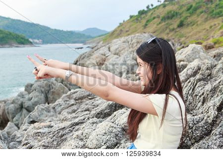 Girl at reef on background of the bay Puket in Thailand
