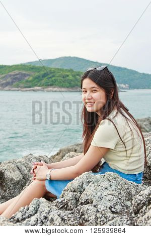 Girl at reef on background of the bay Puket in Thailand