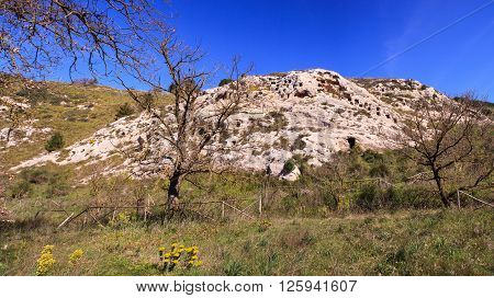 View of the Necropolis of Realmese. Necropoli Pantalicana is an achaeological park in Calascibetta Sicily