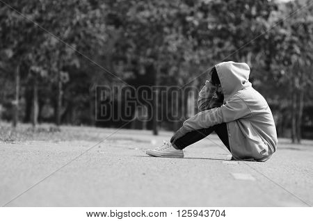 Nervous and Lonely Girl Sitting on the Road