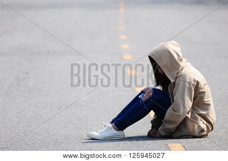 Sad and Heartbroken Girl Sitting on the Road