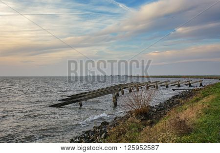 Marken is particularly colorful peninsula in the Markermeer. This picture of breakwaters was taken from an embankment on December 20, 2015.