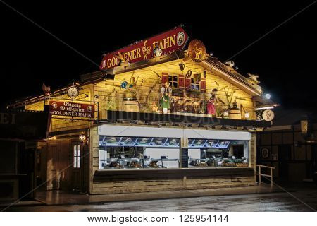 MUNICH, GERMANY - SEPTEMBER 18, 2015: Nightshot of the Golderner Hahn stall on Theresienwiese