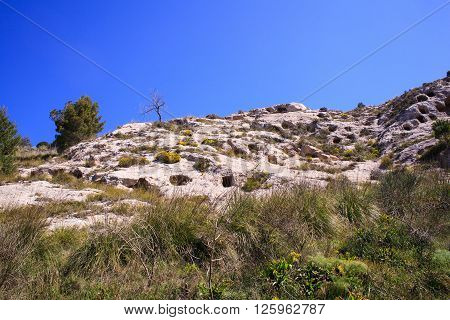 View of the Necropolis of Realmese. Necropoli Pantalicana is an achaeological park in Calascibetta Sicily