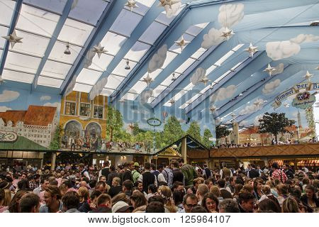 MUNICH, GERMANY - OCTOBER 02, 2015: Inside the Hacker Festzelt (Himmel der Bayern) at Oktoberfest with its lovely decoration of the roof and the surrounding walls