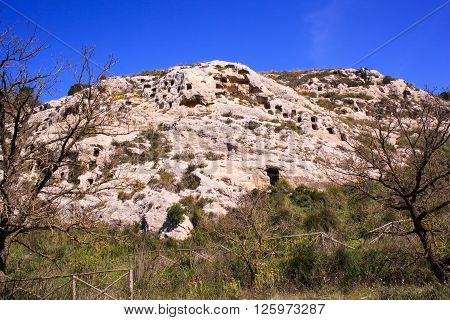 View of the Necropolis of Realmese. Necropoli Pantalicana is an achaeological park in Calascibetta Sicily