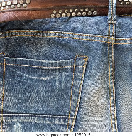 blue jeans with brown leather belt, clothing industry