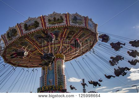 MUNICH, GERMANY - OCTOBER 02, 2015: Carousel in motion with people flying through the air on Theresienwiese