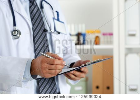 Male Medicine Doctor Hand Holding Silver Pen Writing