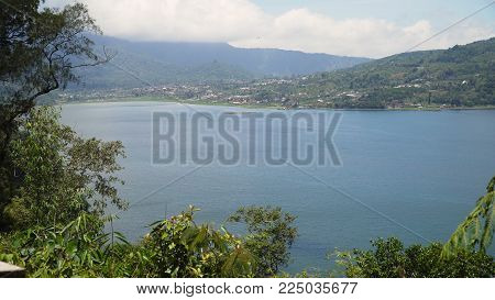 Lake Buyan, caldera lake at Bali. Beautiful lake with turquoise water in the mountains of the island of Bali. Landscape, lake among mountains, sky, clouds.