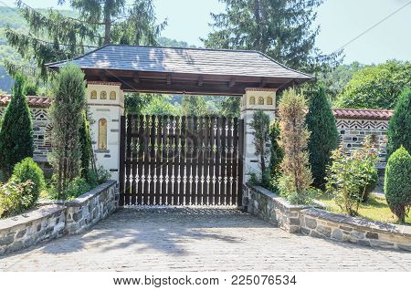 VALEA JIULUI, ROMANIA - AUGUST 1, 2017: The old Lainici Monastery on a summer's day, detail of entrance gate.