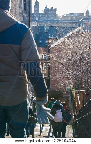 Tourists Walking Down North Castle Wynd Staits Nearby Edinburgh Castle.