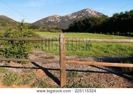 Wooden fence in Poway, California with Iron Mountain in the background.