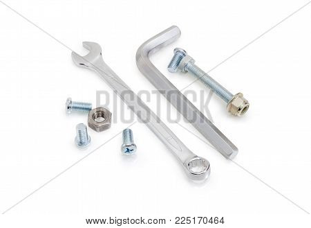 Chrome-plated combination wrench open at one end and ring at the other and hex key among of bolts, screws, nuts on a white background