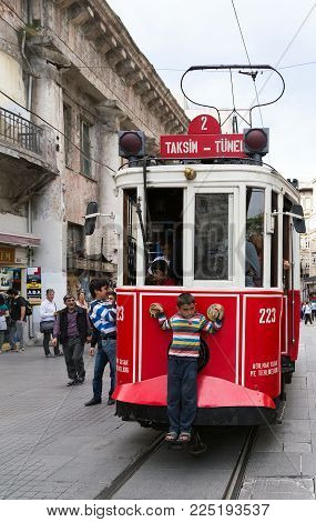 Istanbul, Turkey - May 05, 2014: Nostalgic Red With Pedestrians Boy Tram Is The Heritage Tramway Sys