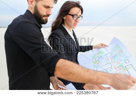 Designer Man And Representative Of Investment Company Woman Holding Whatman Paper With Plan, People 