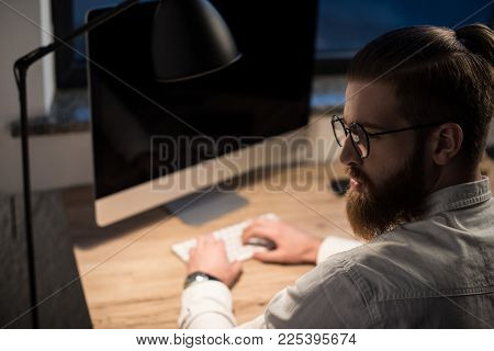 Businessman Typing Something On Keyboard In Office And Looking Away