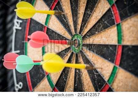 Colorful Dart Target Game With One Win Arrow Hit On Middle Point Spot And Many Missing For Competiti