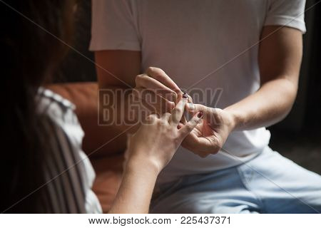 Man Putting Ring On Womans Finger, Boyfriend Making Marriage Proposal Proposing To Girlfriend, Casua