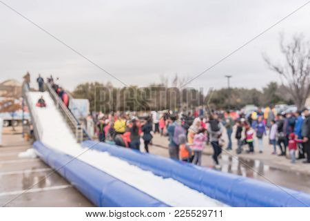 Blurred Giant Snow Tube Inflatable Slide At Community Event In Usa