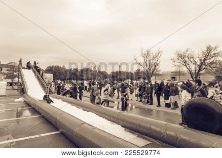 Blurred Giant Snow Tube Inflatable Slide At Community Event In Usa