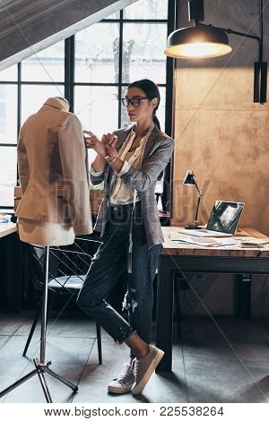 Successful Fashion Designer. Full Length Of Serious Young Woman In Eyewear Using Sewing Needles For 