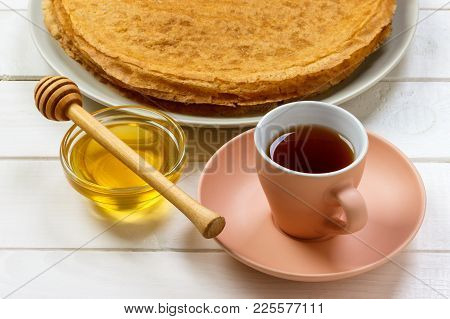 Hot Pancakes With Honey On A Plate, Breakfast Tea With Crepes.