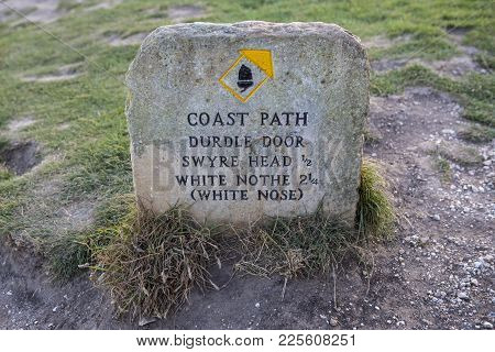 A Marker On The South West Coast Path Showing Directions To Durdle Door, Swyre Head And White Nothe 