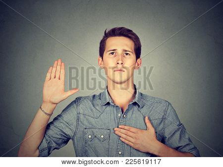 Young Serious Confident Man Making A Promise