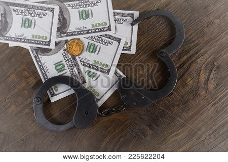 Handcuffs On A Pile Of American Banknotes. The Symbolic Meaning Of Economic Crimes. Copy Paste