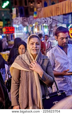 Tehran, Iran - April 27, 2017: Muslim Woman In Religious Veil Stands On The Oriental Bazaar Near Sha