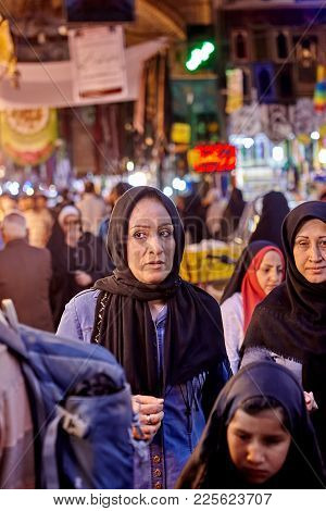 Tehran, Iran - April 27, 2017: Iranian Woman In Hijab Stands In The Oriental Bazaar Near Shahr-e-rey