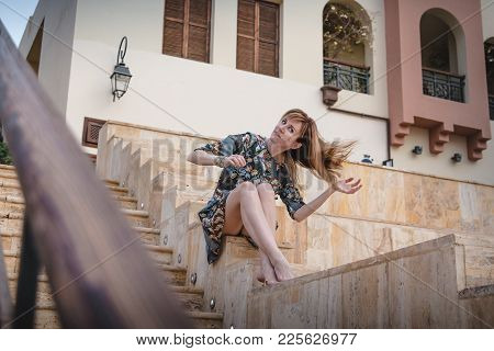 Girl In Grey Dress On Stairs In A Summer Day