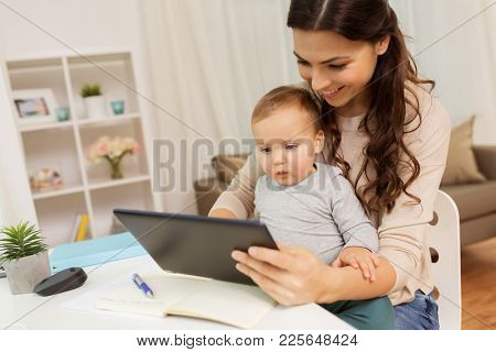 multi-tasking, education, motherhood and technology concept - happy mother student with baby and tablet pc computer learning at home