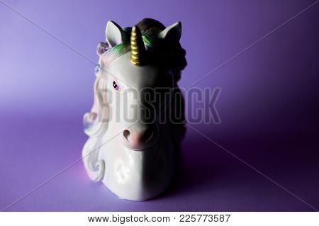 Closeup Unicorn Figure On Ultraviolet Background Half Light Half Shadow