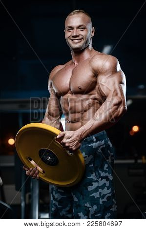 Brutal Strong Bodybuilder Athletic Men Pumping Up Muscles With Dumbbells.