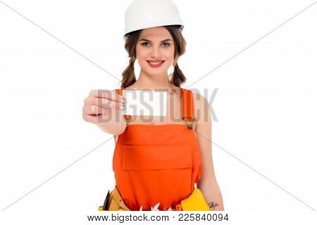 Smiling Workwoman In Uniform And Hardhat Holding Business Card, Isolated On White