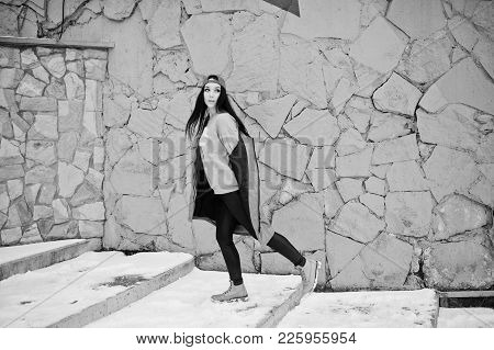 Stylish Brunette Girl In Gray Cap, Casual Street Style On Winter Day Against Colored Wall.