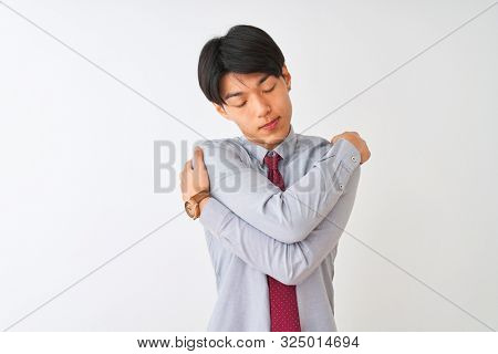 Chinese businessman wearing elegant tie standing over isolated white background Hugging oneself happy and positive, smiling confident. Self love and self care