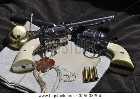 Still-life With Two Revolvers, Parcel, Inkwell, Wedding Rings And Bullet Cartridges