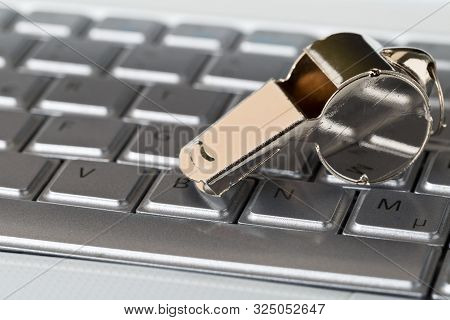 Chrome Whistle On Top Of Laptop Computer Keyboard - Whistleblower Concept, Selective Focus