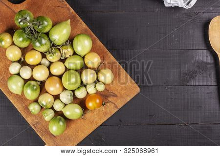 Green Fresh Tomato On A Wooden Kitchen Board, Vegetarian Food, Healthy Nutrition, Fresh Tomatoes