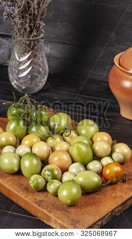 Green Fresh Tomato On A Wooden Kitchen Board, Vegetarian Food, Healthy Nutrition, Fresh Tomatoes
