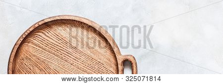 Empty Round Wooden Dish On Grey Concrete Background, Banner, Copy Space For Your Text