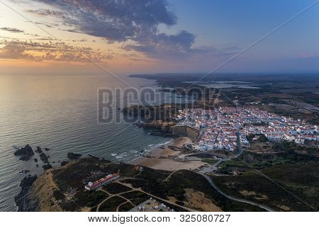 Aerial View Of The Zambujeira Do Mar Village And Beach At Sunset, In Alentejo, Portugal;