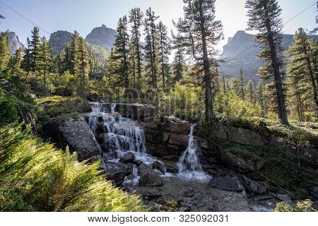 A Beautiful Waterfall In The Forest. Wildlife, Waterfalls In A Deserted Forest. Taiga. Strong And Ta