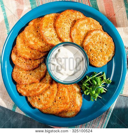 Homemade Potato Pancakes, Latkes, Draniki, Hash Browns Or, Fritters Served With Sour Cream And Sunfl